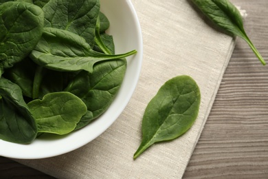 Fresh green healthy spinach leaves on wooden table, flat lay