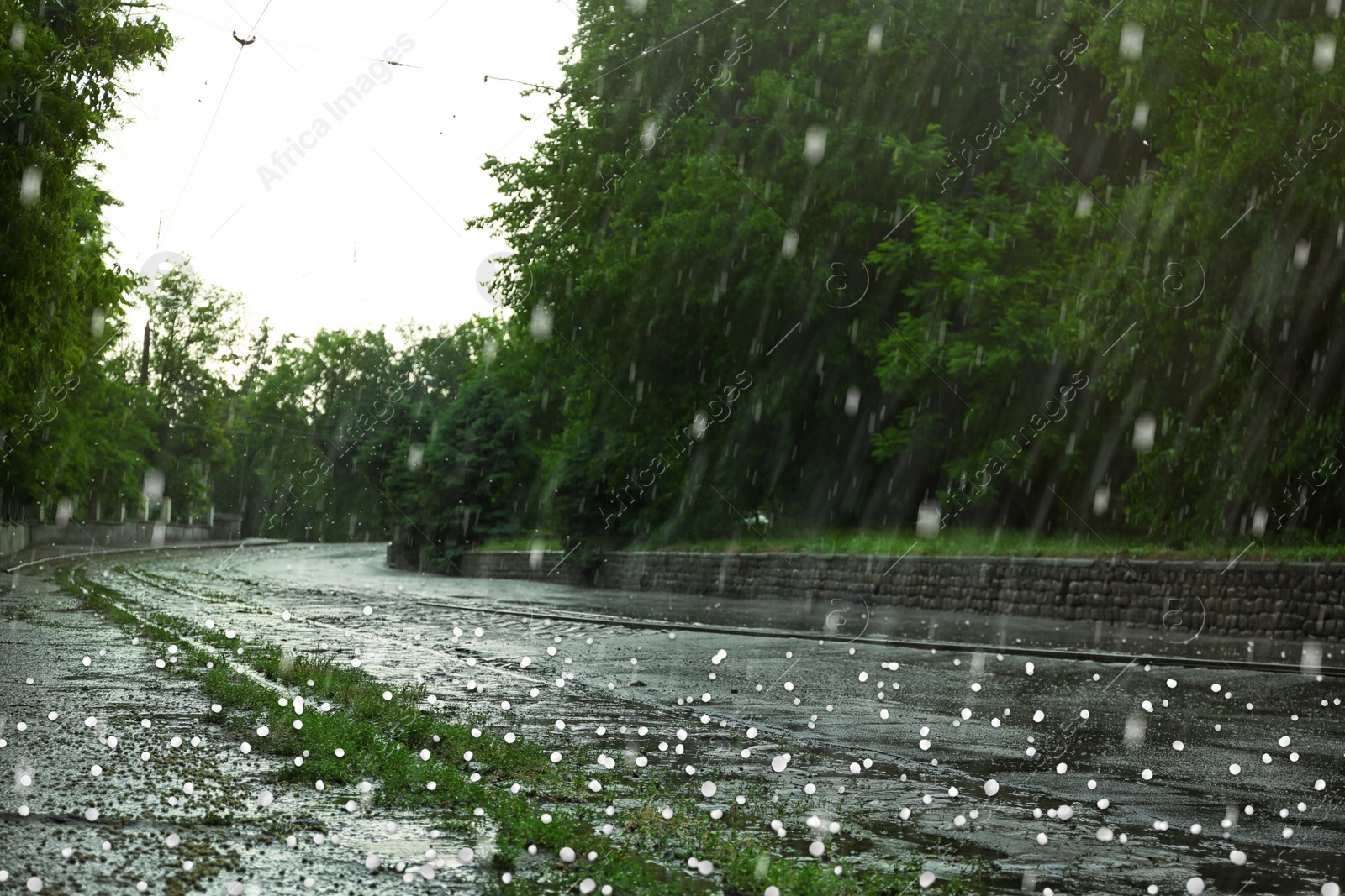 Image of View of city street on rainy day with hail