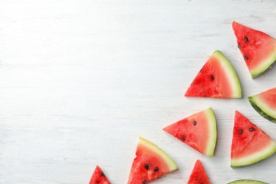 Slices of watermelon on wooden background, flat lay composition with space for text