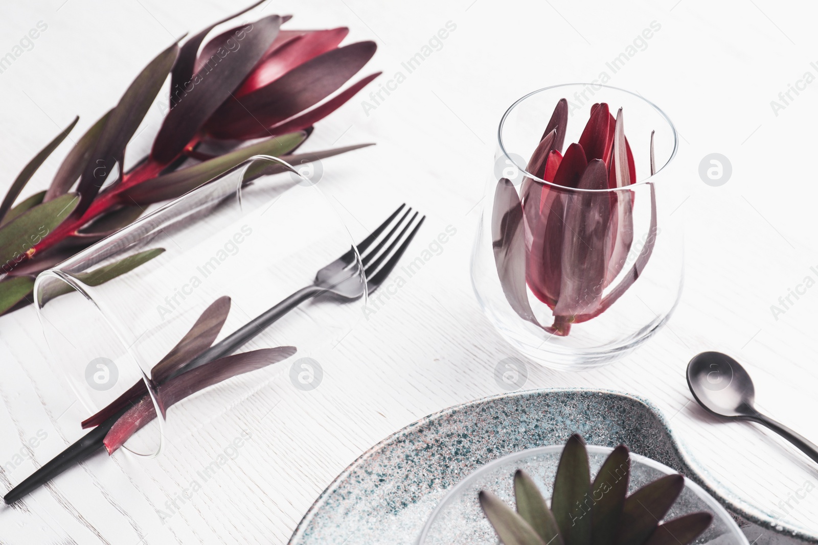 Photo of Elegant table setting with floral decor on white wooden background