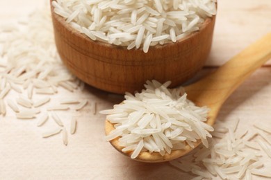 Photo of Raw basmati rice on white wooden table, closeup