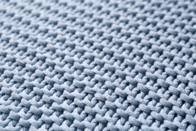Beautiful light blue knitted fabric as background, closeup