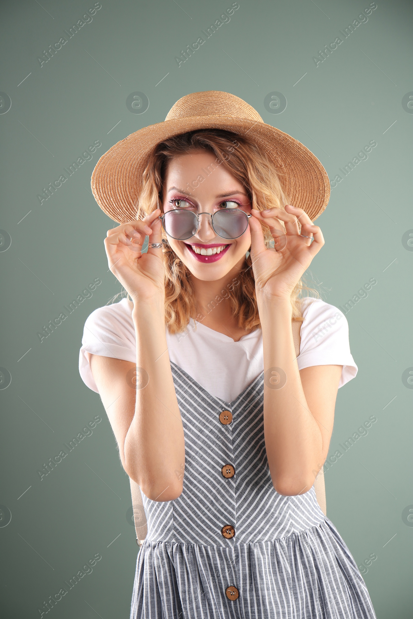 Photo of Beautiful young woman posing on color background. Summer fashion