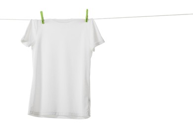 One t-shirt drying on washing line isolated on white