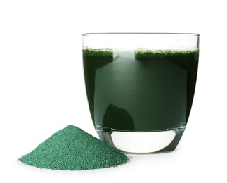 Photo of Glass with spirulina drink and pile of powder on white background