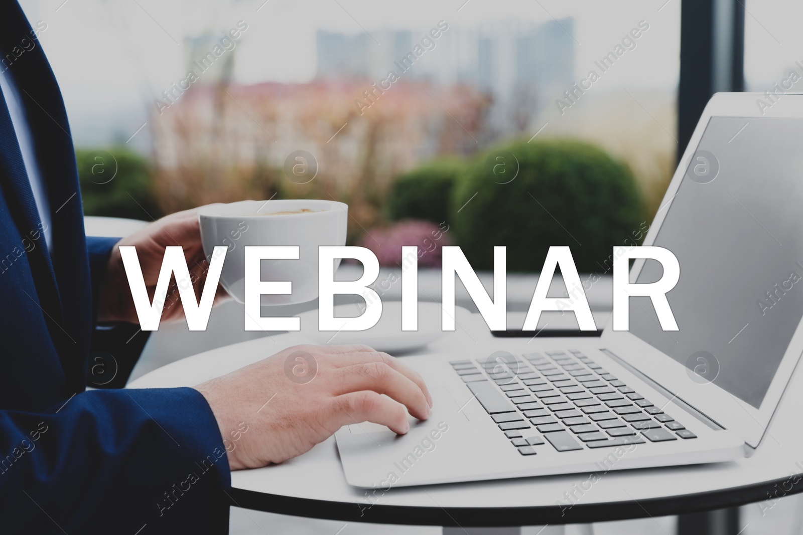 Image of Man working with laptop in outdoor cafe, closeup. Business webinar