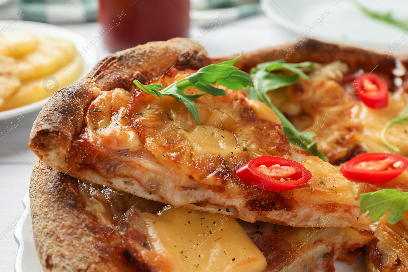 Photo of Delicious Hawaiian pizza with pineapple on white table, closeup