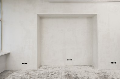 Photo of Empty white wall in room prepared for renovation