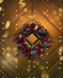 Beautiful Christmas wreath hanging on wooden door