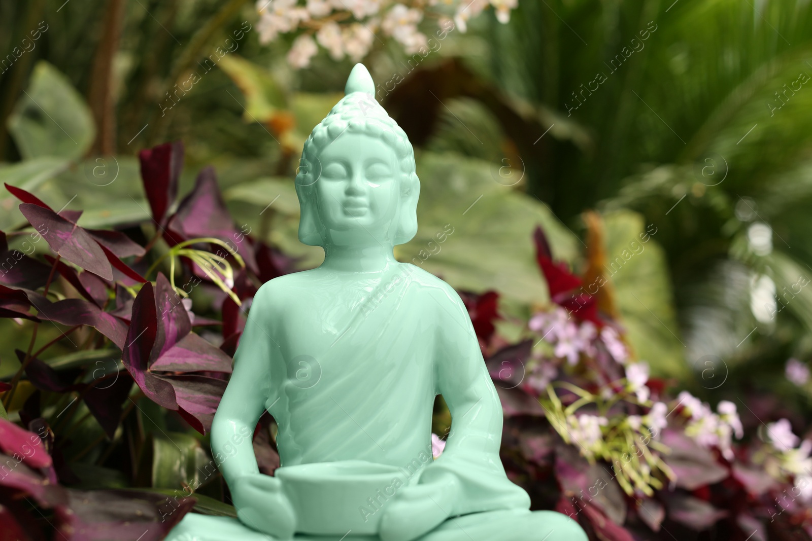 Photo of Decorative Buddha statue outdoors, closeup. Space for text