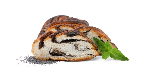 Photo of Cut poppy seed roll and mint leaves isolated on white. Tasty cake