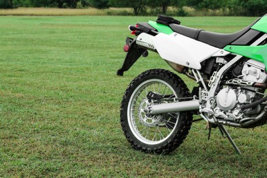 Photo of Stylish green cross motorcycle outdoors, space for text