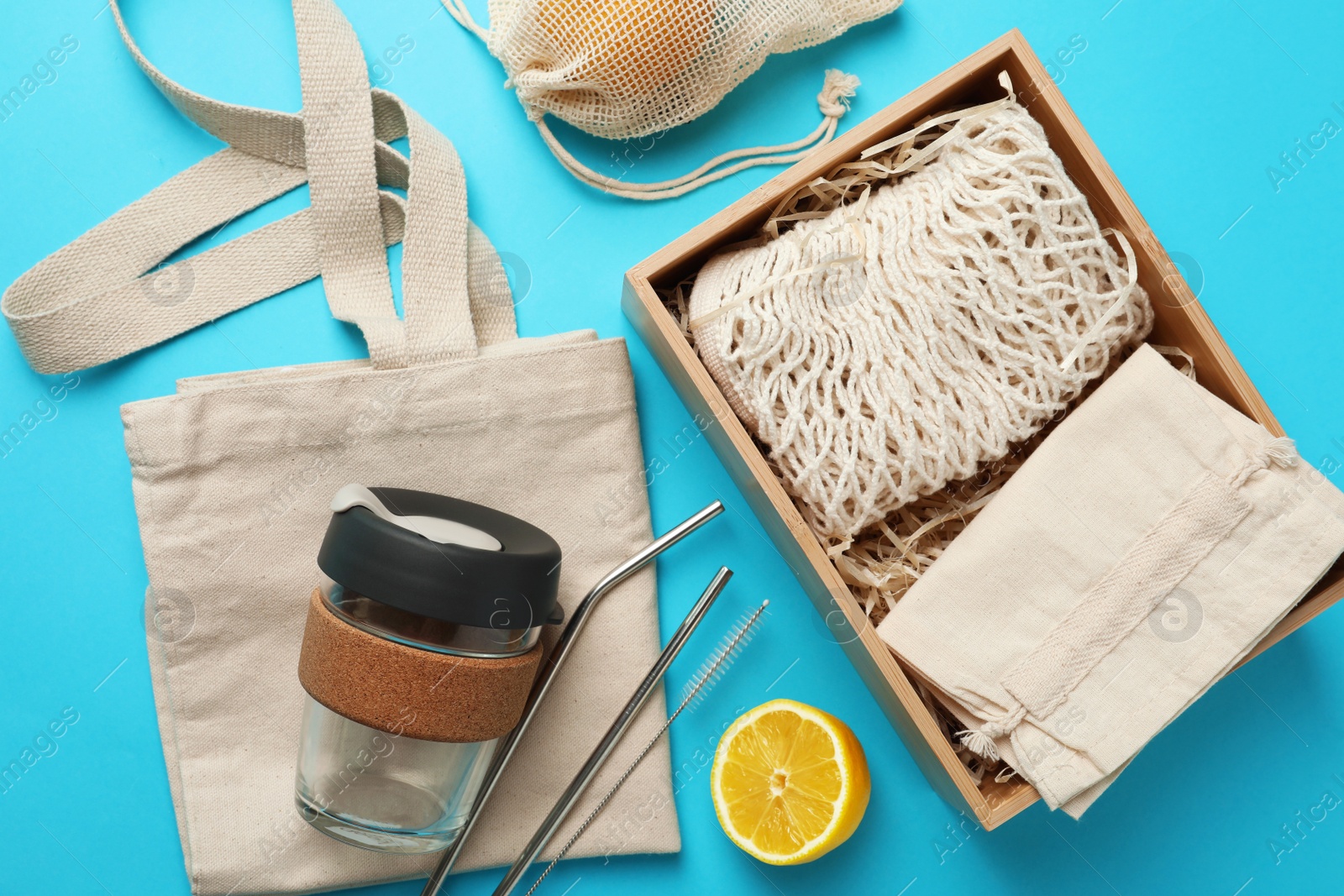 Photo of Flat lay composition with eco friendly products on light blue background