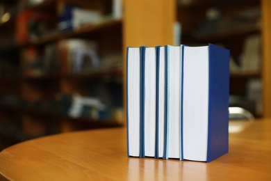 Books on table in library. Space for text