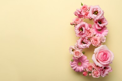 Photo of Number 8 made of beautiful pink flowers on beige background, flat lay with space for text. International Women's day