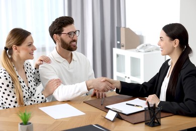 Photo of Lawyer shaking hands with clients in office