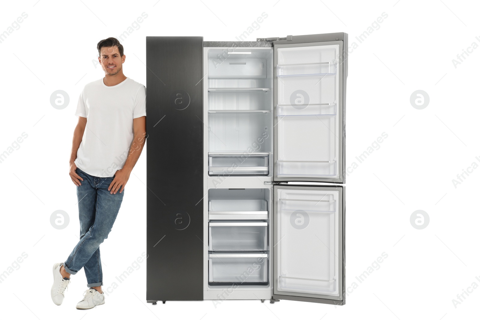 Photo of Man near open empty refrigerator on white background