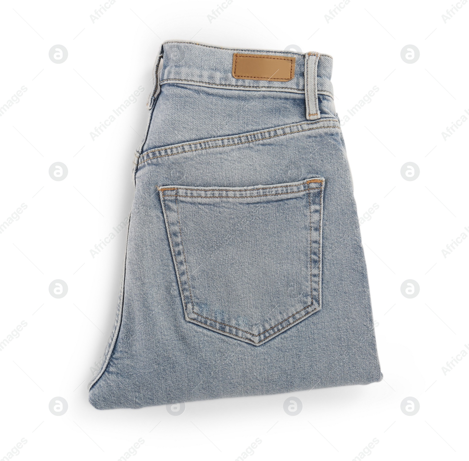 Photo of Light blue jeans isolated on white, top view. Stylish clothes