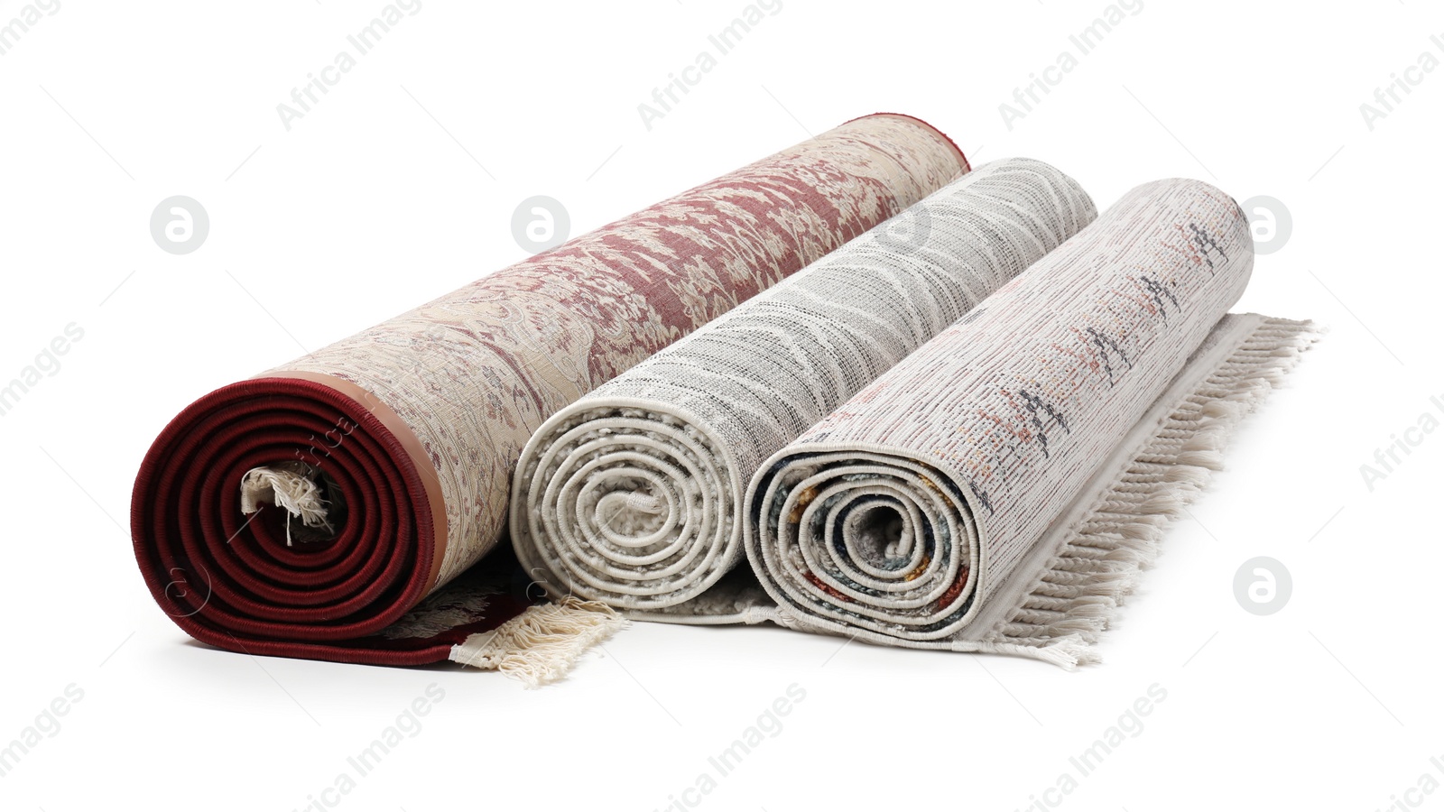 Photo of Rolled carpets on white background. Interior element