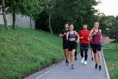 Group of people running outdoors. Space for text