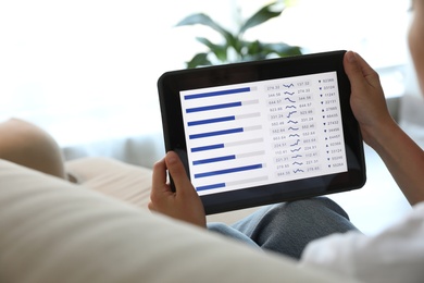 Woman working with tablet at home, closeup