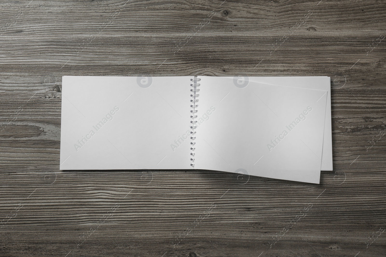 Photo of Blank paper brochure on wooden table, top view. Mockup for design