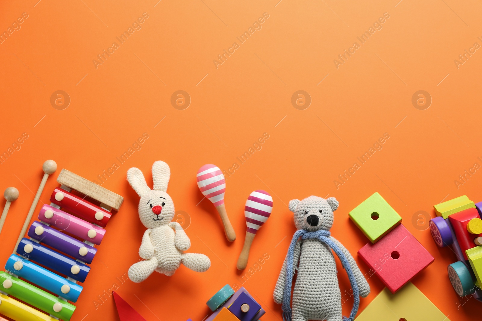 Photo of Flat lay composition with different toys on orange background. Space for text