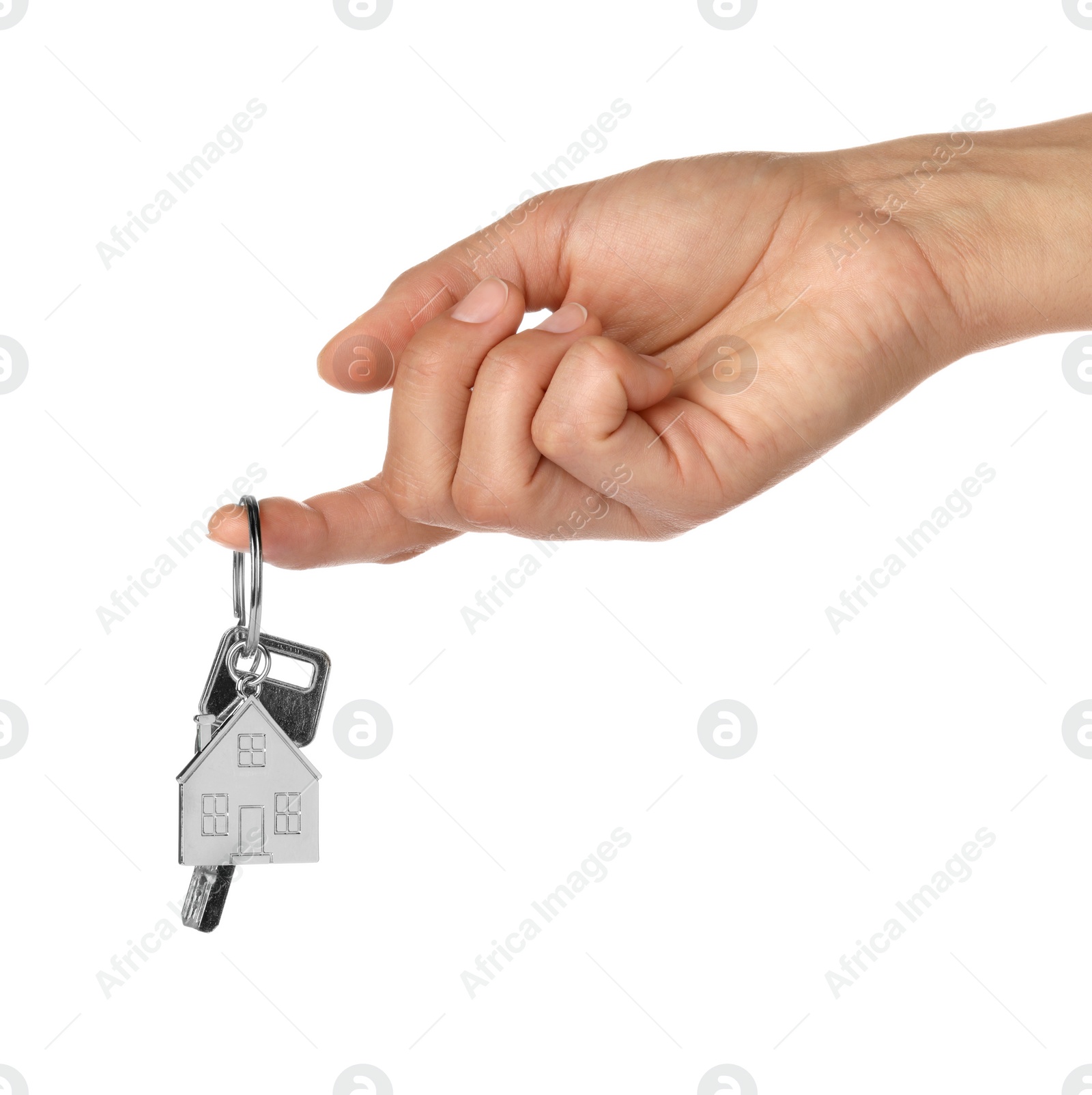 Photo of Woman holding key with metallic keychain in shape of house on white background, closeup