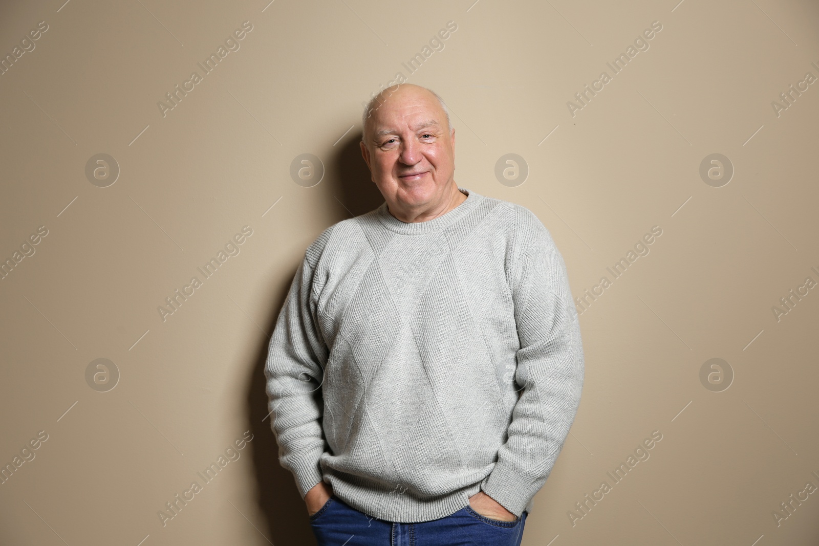 Photo of Portrait of elderly man on color background