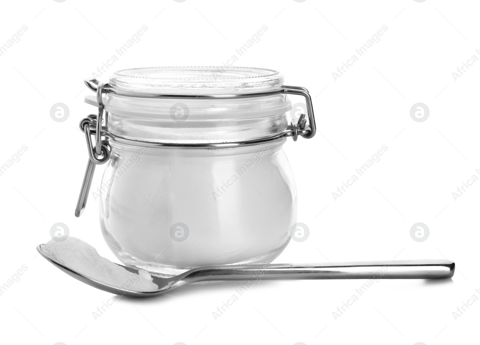 Photo of Spoon and jar with baking soda on white background