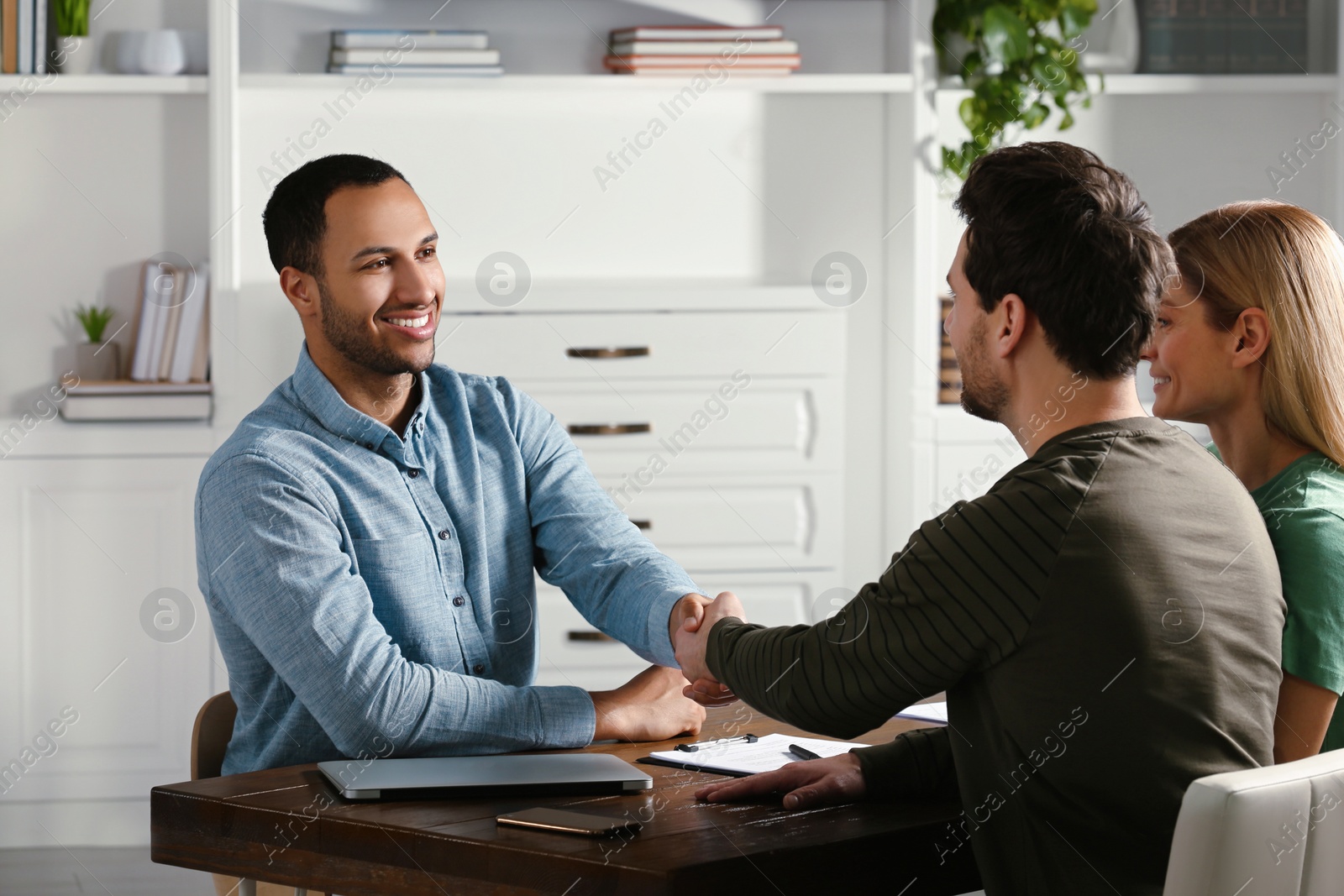 Photo of Notary shaking hands with client in office