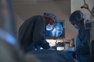 Photo of Professional doctors performing operation in surgery room