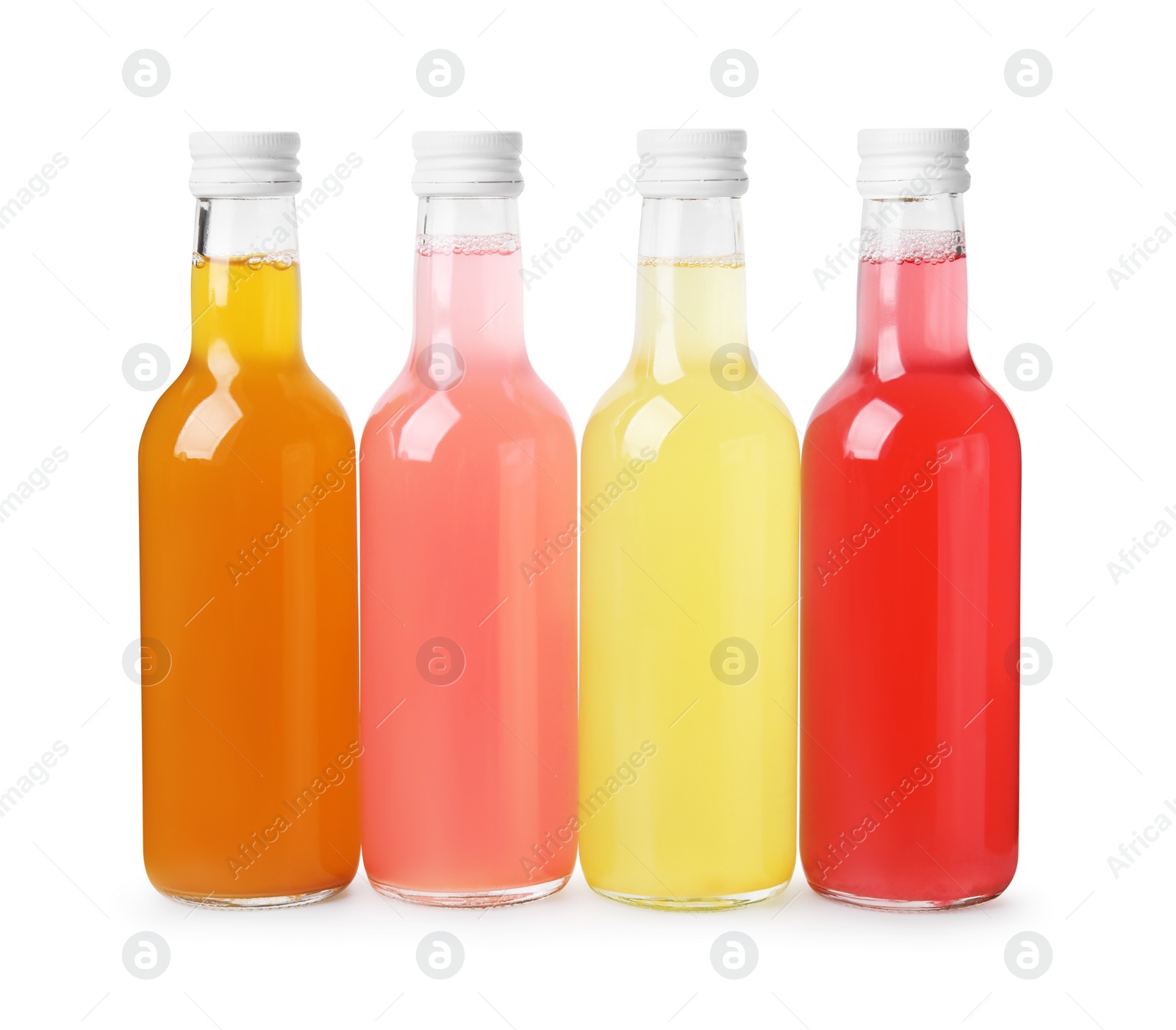 Photo of Delicious kombucha in glass bottles isolated on white