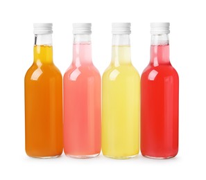 Photo of Delicious kombucha in glass bottles isolated on white