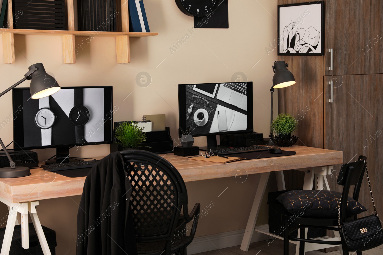 Photo of Stylish workplace interior with computers on table