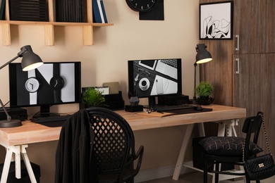 Stylish workplace interior with computers on table