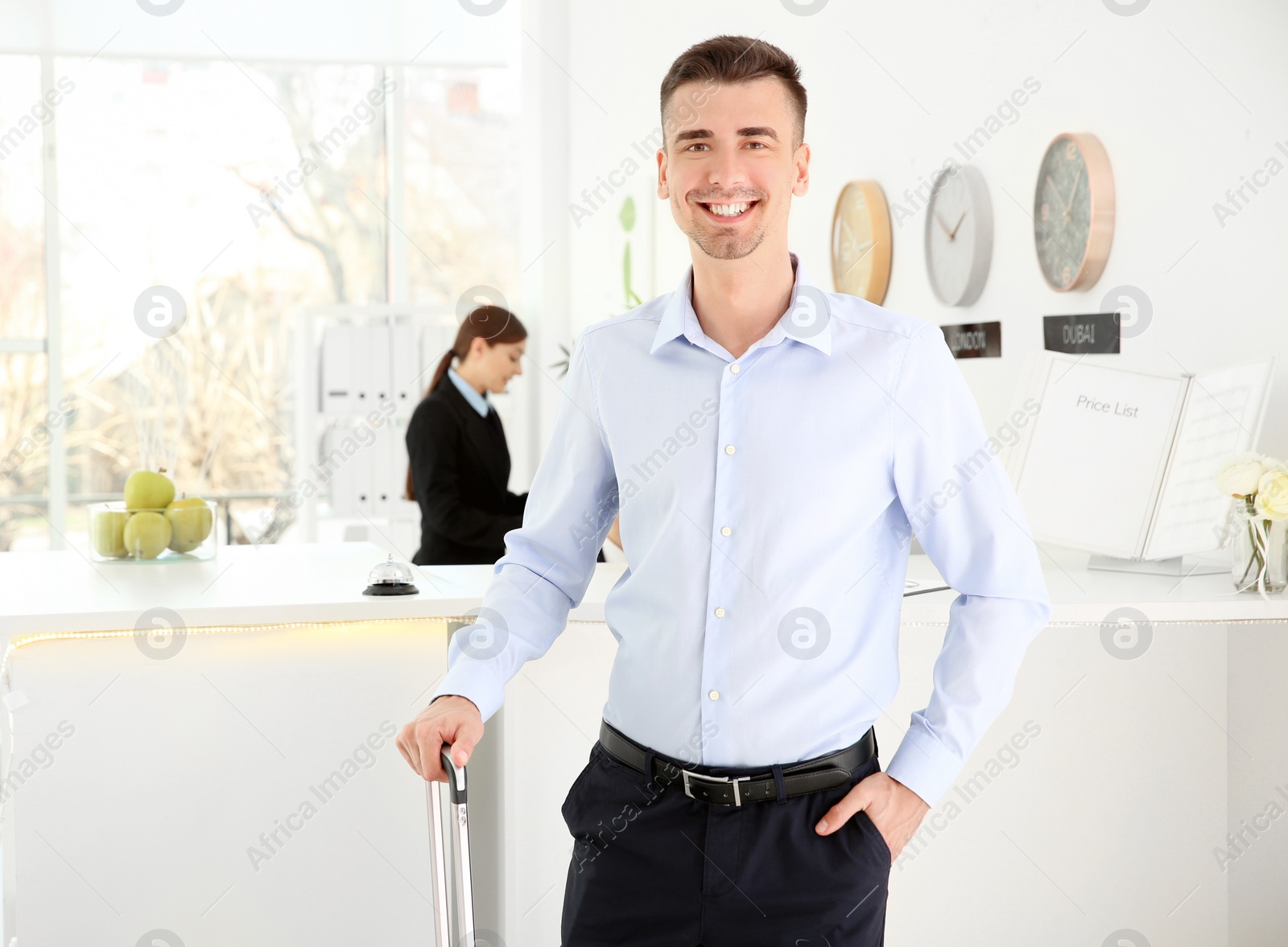 Photo of Young man near reception desk in hotel