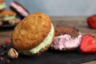 Photo of Sweet delicious ice cream cookie sandwiches on table, closeup