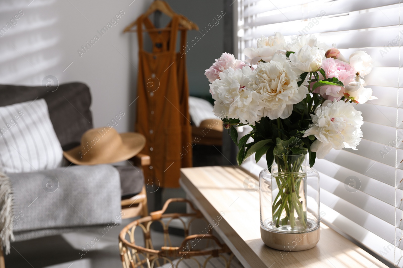 Photo of Bouquet of beautiful peony flowers on window sill indoors. Space for text