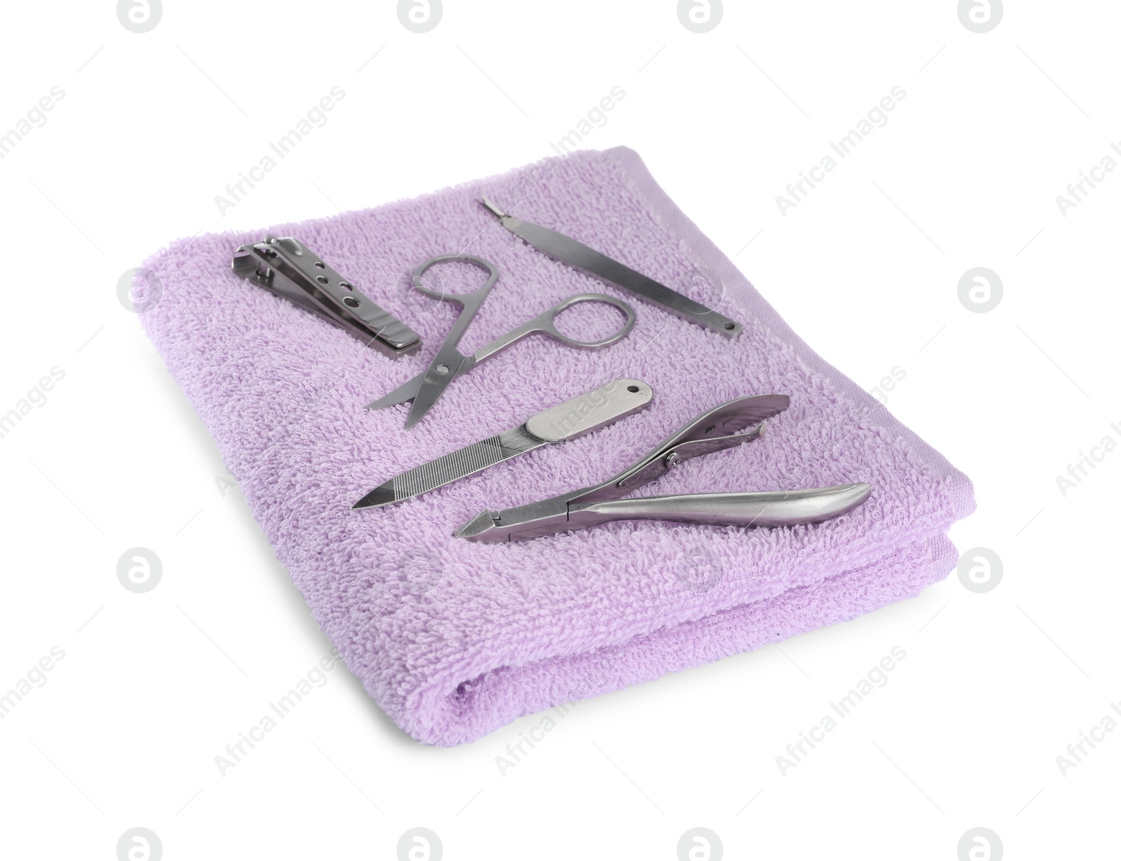 Photo of Manicure set on soft towel, white background