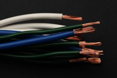 Photo of Electrical wires on black background, closeup view