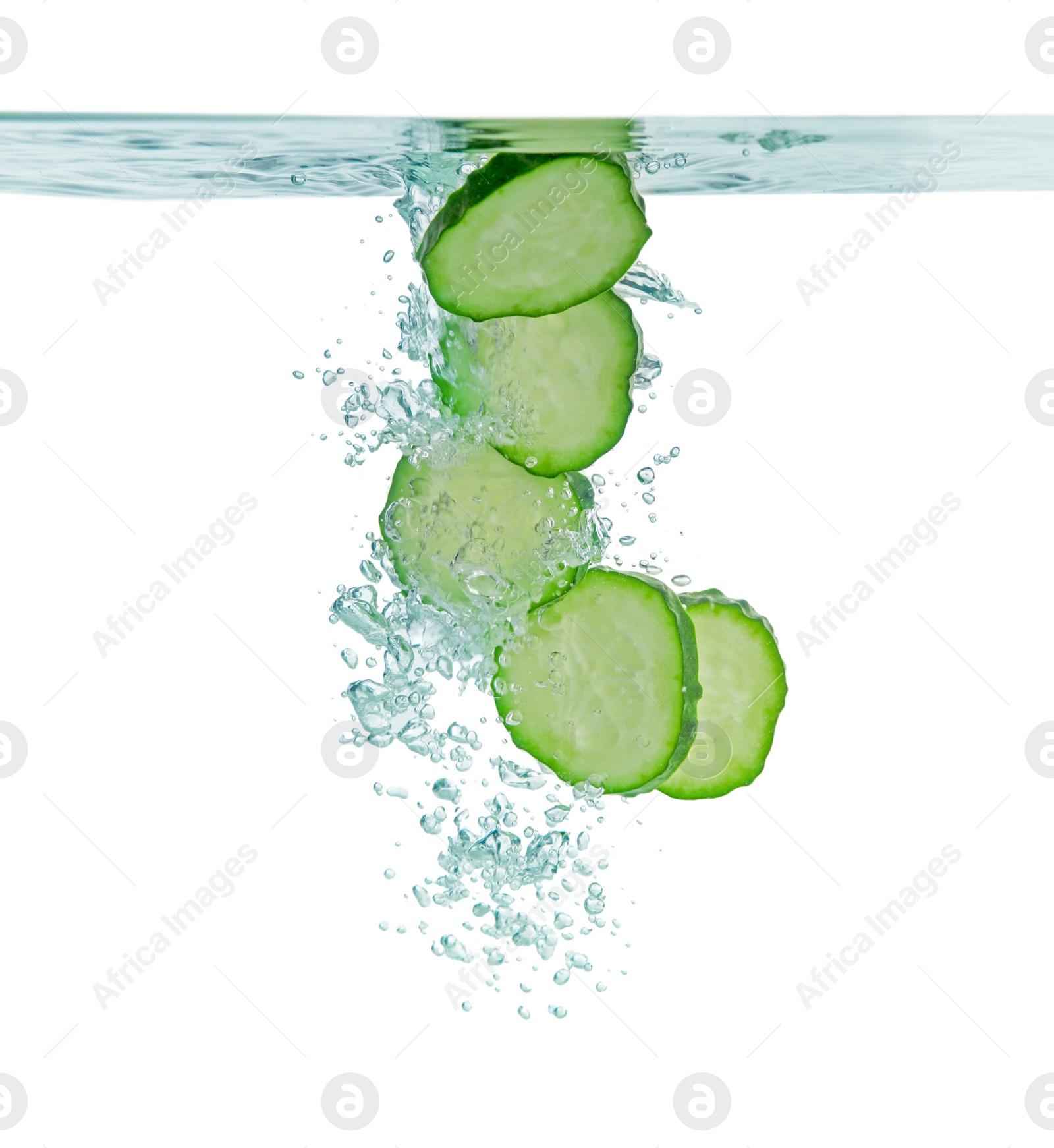 Photo of Fresh cucumber slices in water on white background