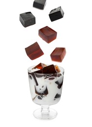 Image of Cubes of tasty grass jelly falling into glass with milk on white background