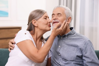 Photo of Senior woman kissing her beloved man indoors