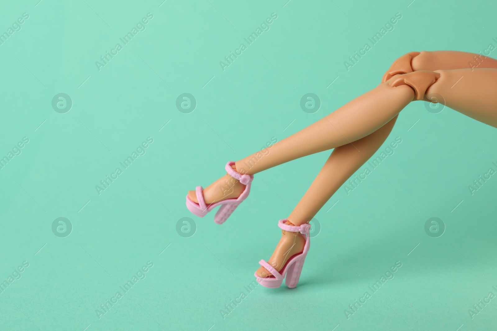 Photo of Mykolaiv, Ukraine - September 2, 2023: Barbie doll wearing beautiful heels on turquoise background, closeup with space for text