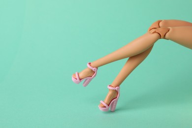 Photo of Mykolaiv, Ukraine - September 2, 2023: Barbie doll wearing beautiful heels on turquoise background, closeup with space for text