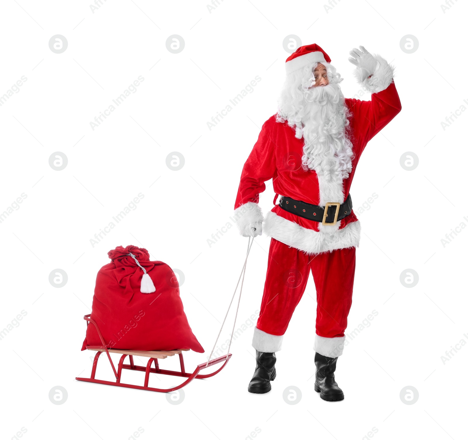 Photo of Man in Santa Claus costume with bag and sleigh on white background