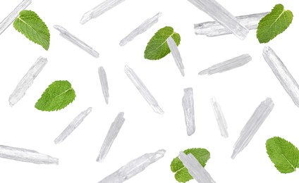 Image of Translucent menthol crystals and green mint leaves falling on white background 