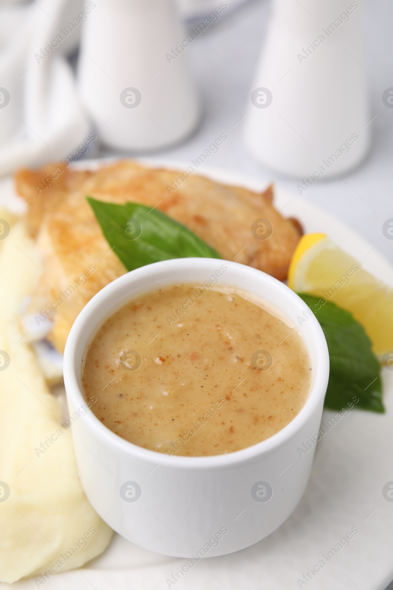 Photo of Delicious turkey gravy served on table, closeup