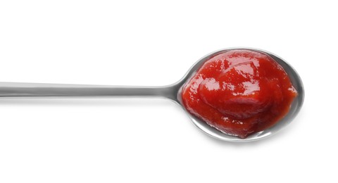 Photo of Tasty ketchup in spoon isolated on white, top view